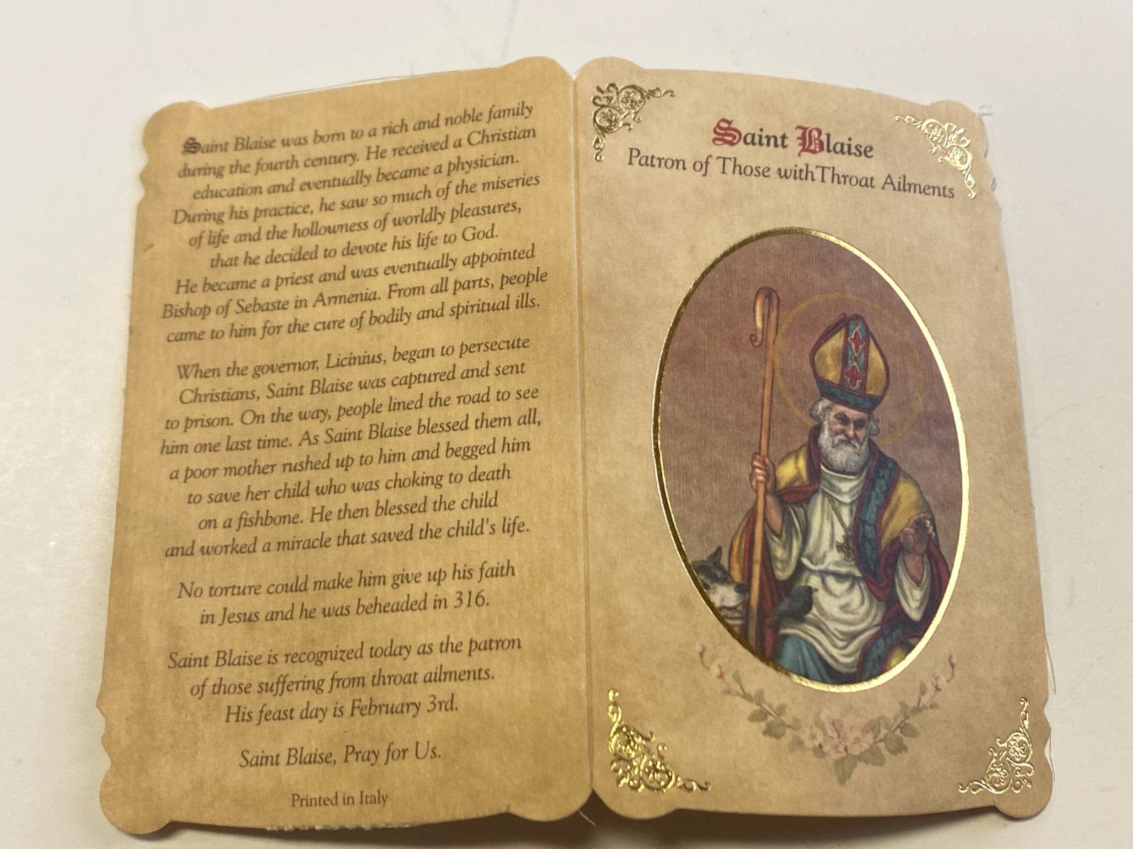 Saint Blaise Prayer folder with medal, Christian Holy Card by Bob and Penny Lord, featuring religious imagery and prayer details.