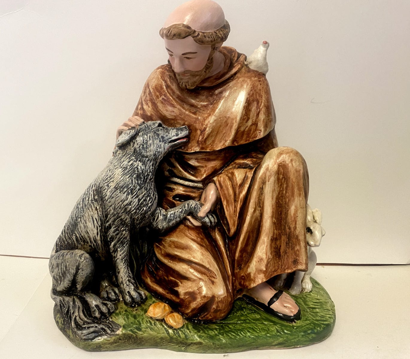 Saint Francis of Assisi with wolf 6.5-inch collectible statue by Bob and Penny Lord, depicting Saint with wolf in natural pose.