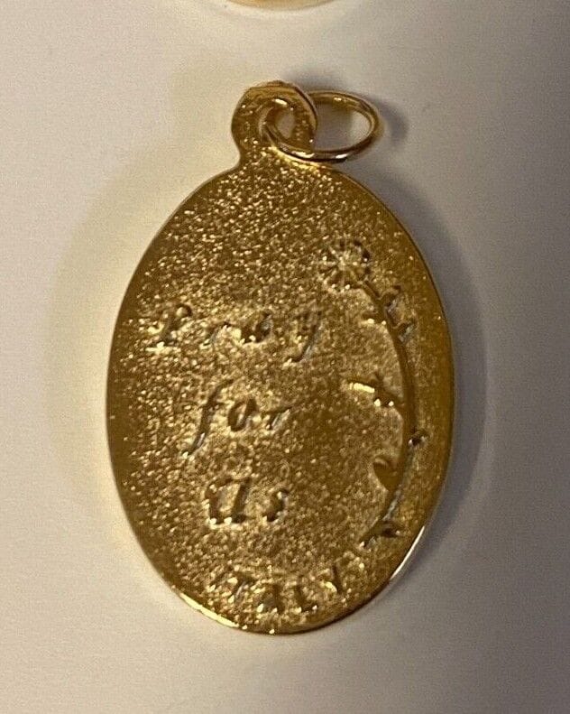 Gold and silver tone St. Michael, Miraculous Medal, and Our Lady of Guadalupe Christian medals by Bob and Penny Lord.