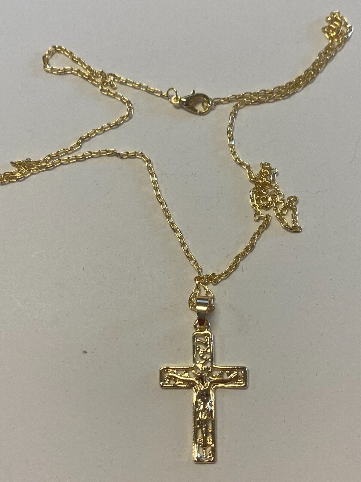 Brazilian gold-plated crucifix necklace, 20-inch fashion jewelry pendant on a chain, showcasing a detailed religious cross design