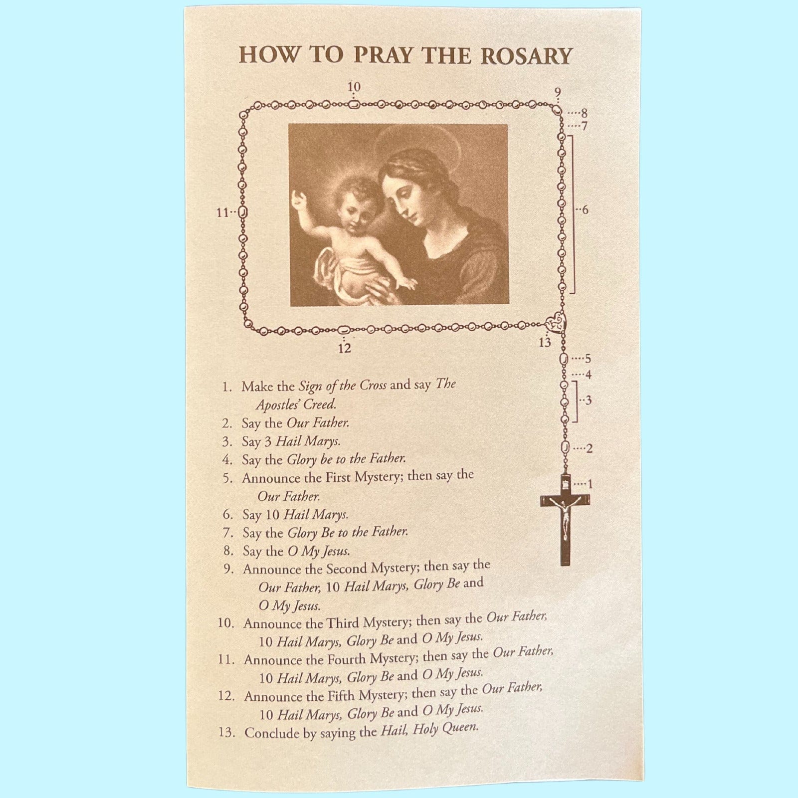 Colorful rosary prayer card by Bob and Penny Lord featuring instructions for praying the rosary, with religious symbols and artwork.