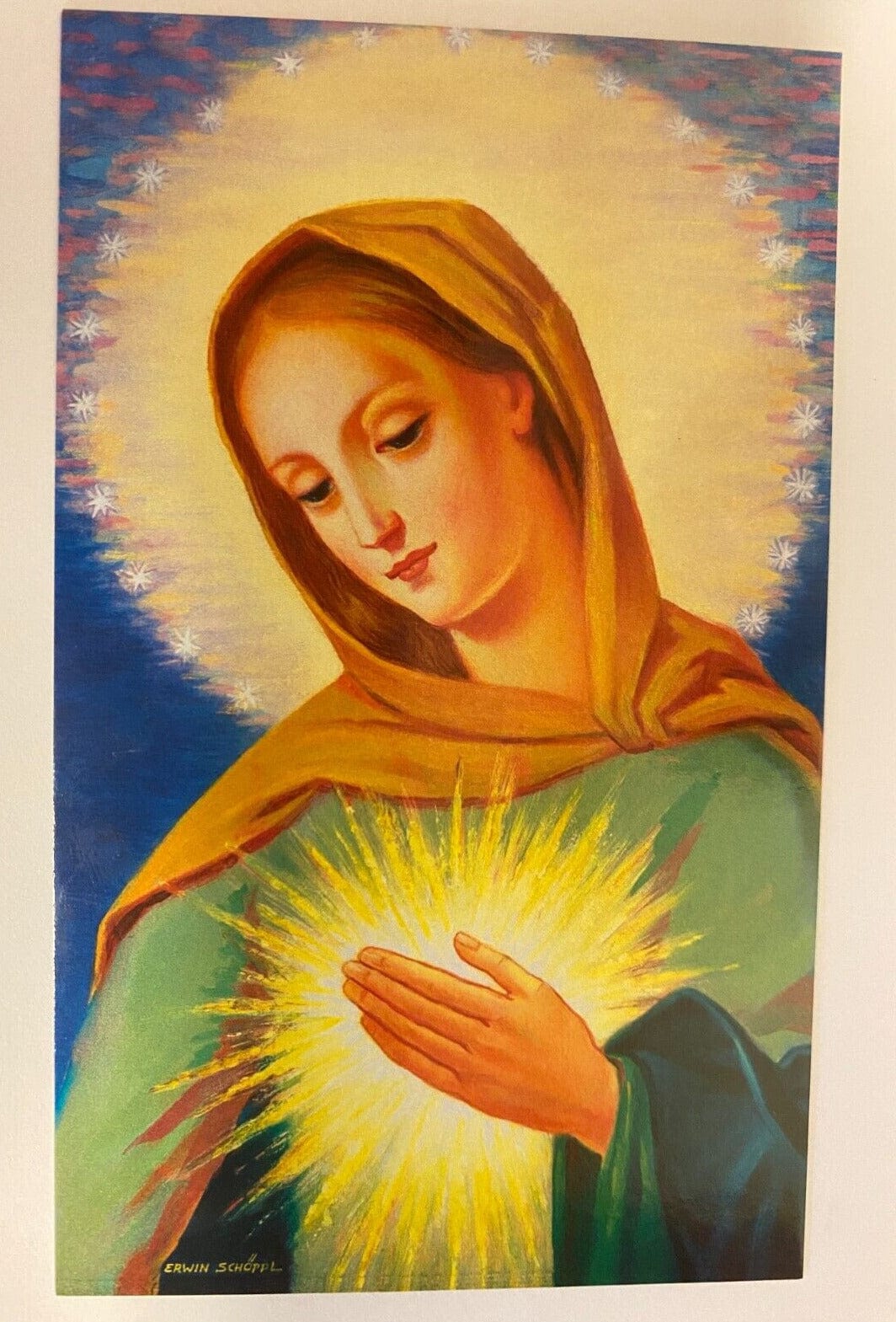 Holy card featuring "La Flama de Amor del Inmaculado Corazon de Maria" from Bob and Penny Lord, with religious imagery and Spanish prayer text.