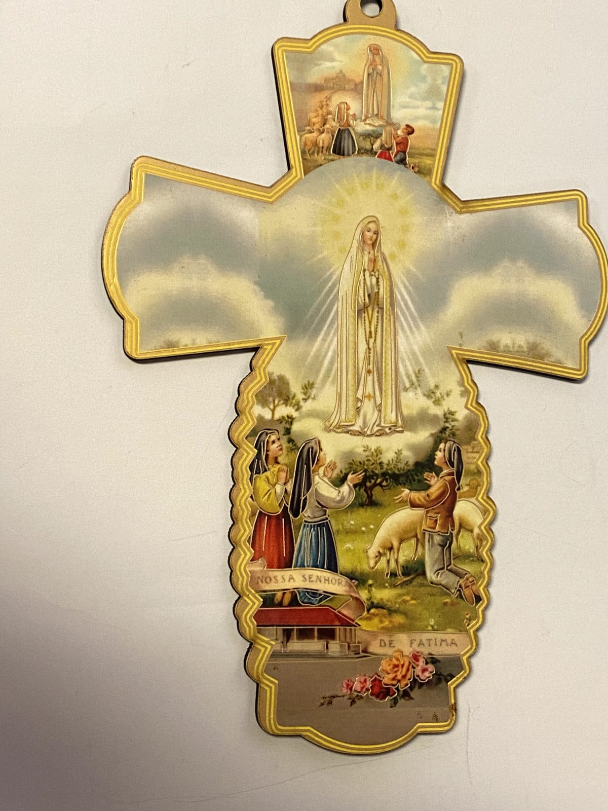 Wood cross featuring Our Lady of Fatima, 7.75-inch decorative collectible from Christian Brand with detailed religious design.