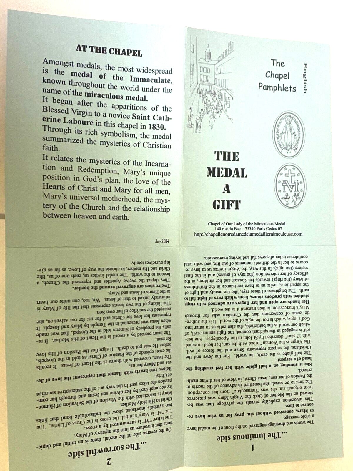 Close-up of the Our Lady of the Miraculous Medal folder featuring a religious medal and Holy Card by Bob and Penny Lord.