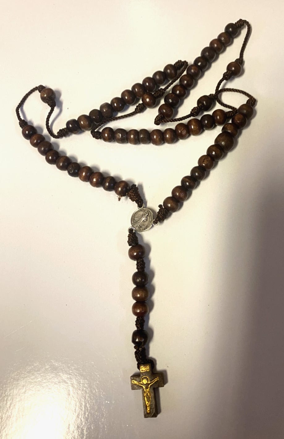 Wood rosary box with Saint Maximilian Kolbe design and a Christian rosary inside, from Bob and Penny Lord, Colombia.