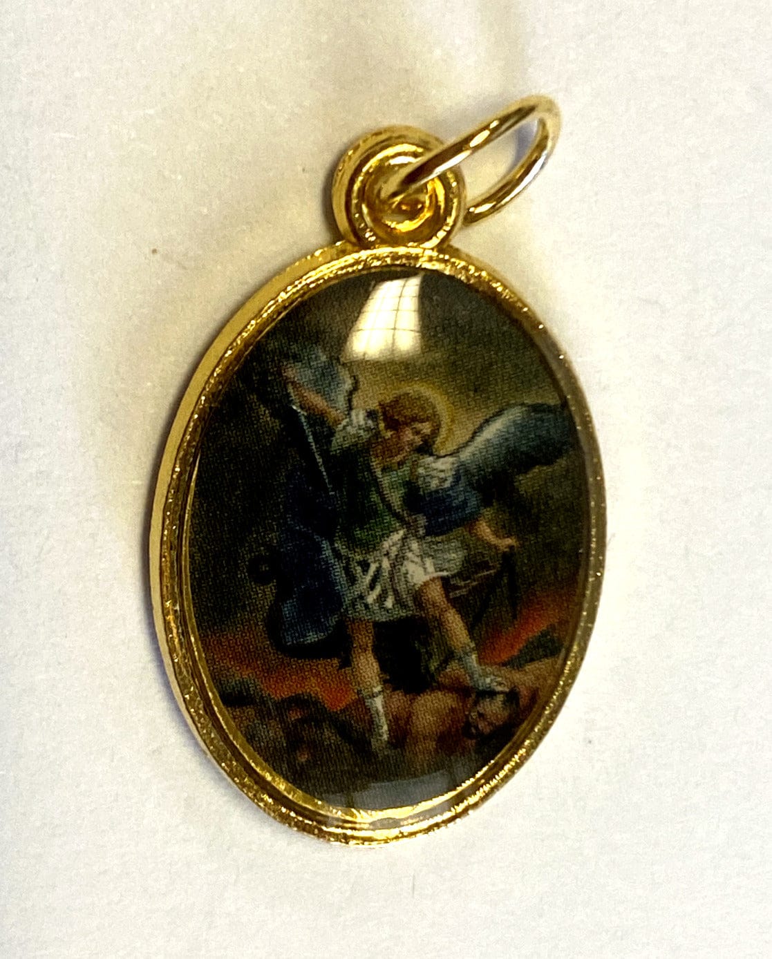 Gold-tone Saint Michael the Archangel medal from Bob and Penny Lord, religious collectible with detailed angel design.