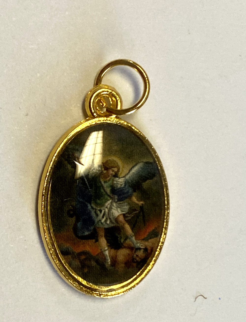 Gold tone Saint Michael the Archangel medal from Bob and Penny Lord, featuring detailed religious Christian iconography.