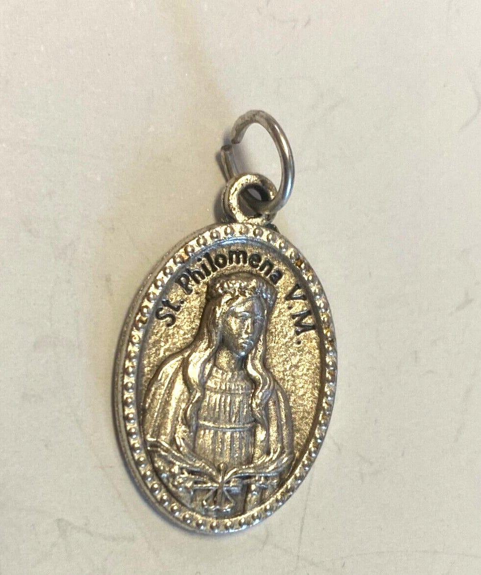 Saint Philomena silver-tone medal from Italy, Christian religious collectible featuring intricate design and spiritual symbolism.
