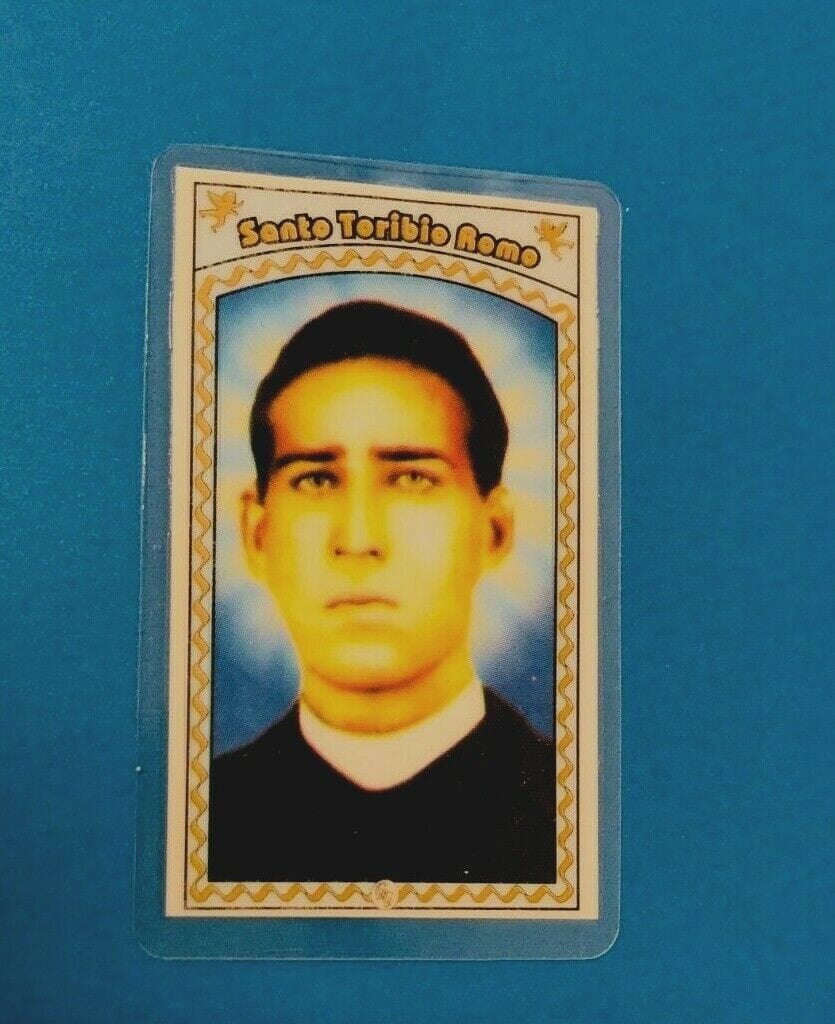 Laminated Santo Toribio Romo prayer card from Bob and Penny Lord, featuring religious imagery and Spanish text.