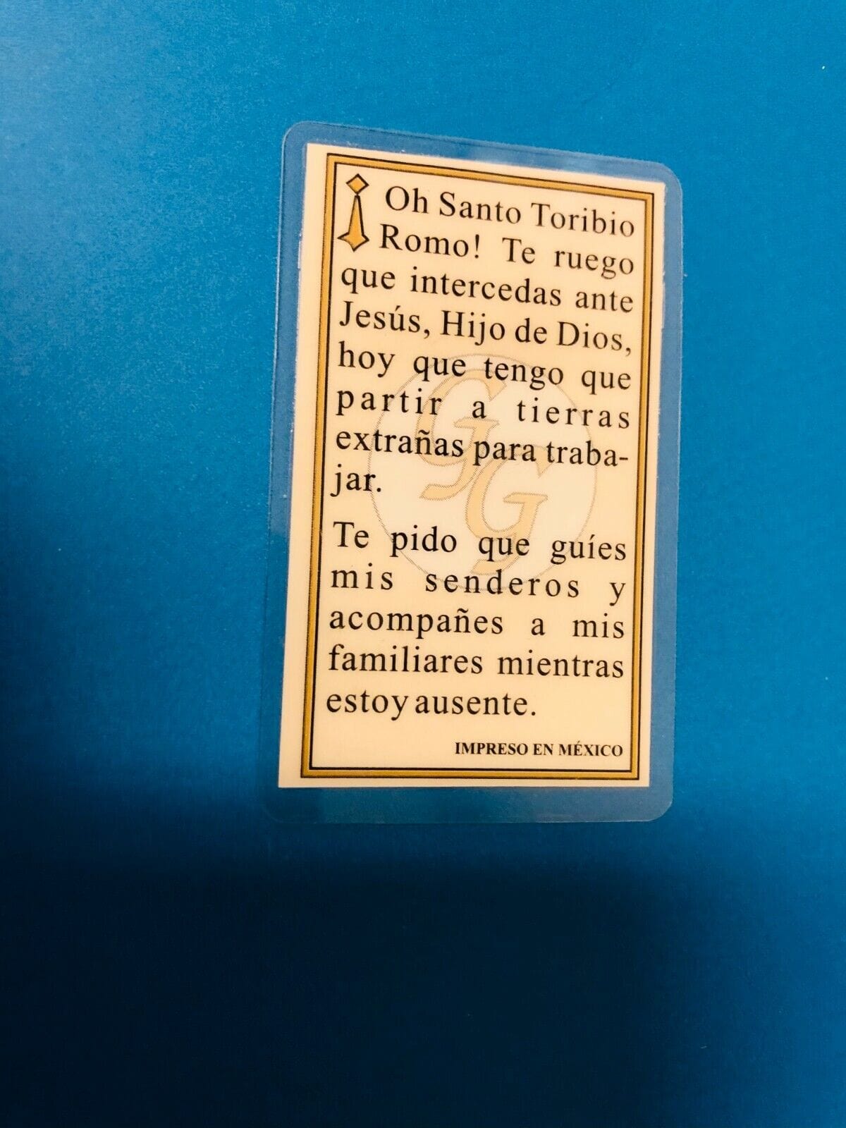 Laminated Santo Toribio Romo prayer card with religious imagery from Bob and Penny Lord, in Spanish, for Christian devotional use.